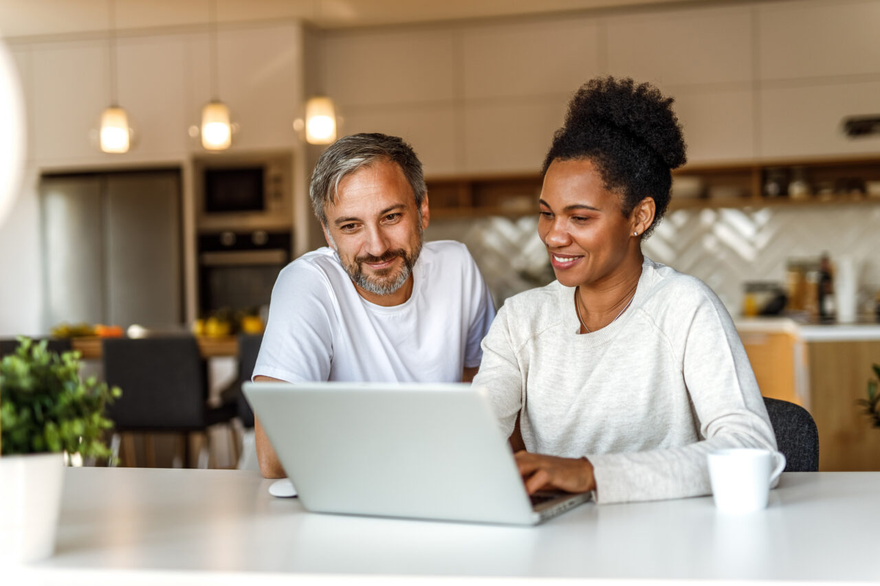 Two adults using AI technology, searching something online.